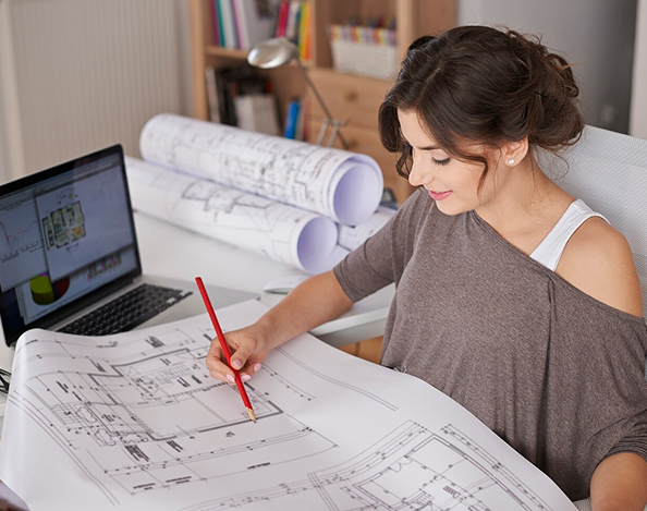 Young creative woman working in professional services at her office desk